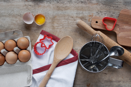 Kitchen items Metal Utensils Spoon Eggs on a wooden table. Cooking Baking Eggs Groceries Top View kitchenwareの写真素材