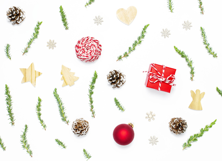 New Year's wooden toys, fir cones, fir branches, gift twine, red gift, Christmas balls on white background. Flat layの写真素材