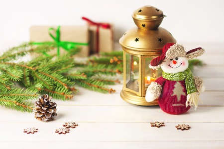 Christmas balls, decorations on a wooden background with spruce branches, with a snowman and a flashlight. Christmas balls, decorations on a wooden background with spruce branches and flashlight.の写真素材