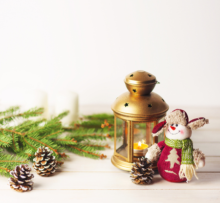 Christmas balls, decorations on a wooden background with spruce branches, with a snowman and a flashlight. Christmas balls, decorations on a wooden background with spruce branches and flashlight.の写真素材