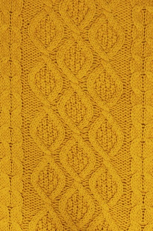 The texture of an orange autumn sweater. Knitted background. Knitted texture A sample of knitting from wool.の写真素材