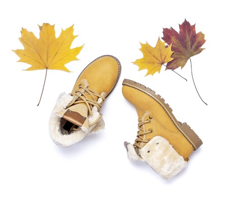 Female orange fashion shoes boots with autumn leaves on white background top view flat lay Fashion Lady Footwear Set Trendy Autumn accessories Female fashion lookの写真素材