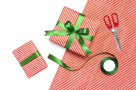Gift boxes, packing paper, scissors, ribbon on white background. Festive background, congratulation, gift wrapping, Christmas and new year theme. Flat lay top view copy space.の写真素材