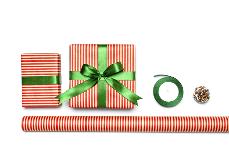 Gift boxes, packing paper, scissors, ribbon on white background. Festive background, congratulation, gift wrapping, Christmas and new year theme. Flat lay top view copy space.の写真素材