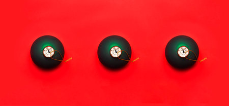 Three Green Christmas ball on red background Flat lay top view copy space. Christmas winter decoration Xmas holiday. Congratulations background New Year conceptの写真素材