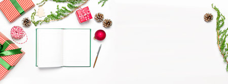 Open notebook with blank pages, gift boxes, fir branches on white background flat lay top view. Christmas planning concept Holiday decorations 2019 Goals. New Year, Christmas winter decorationの写真素材