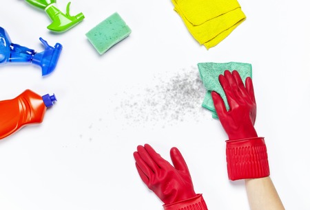 Female hands in red rubber protective gloves with a microfiber cloth isolated on white background top view copy space. Cleaning concept, household, cleaning company, detergents cleaning accessoriesの写真素材