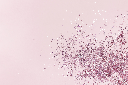 Pink holographic glitter confetti in the form of stars on pink background Flat lay top view copy space. Festive holiday pastel backdrop. Birthday, congratulations Christmas, New Yearの写真素材