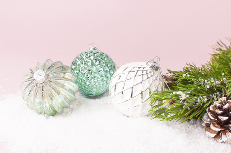 Vintage Christmas New Year balls in the snow and pine branches on pink background Flat Lay copy space. Holiday Baubles, beautiful Decoration Festive decor celebration Xmas holiday greeting cardの写真素材
