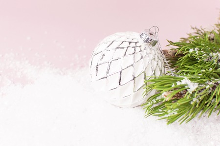 Vintage Christmas New Year balls in the snow and pine branches on pink background Flat Lay copy space. Holiday Baubles, beautiful Decoration Festive decor celebration Xmas holiday greeting cardの写真素材