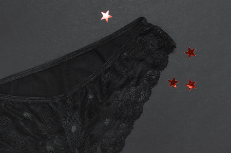 Female black lace panties on dark background top view flat lay with copy space for text. Fashion blog, Female essential erotic clothes, fashionable beautiful panties, advertising, shopping conceptの写真素材