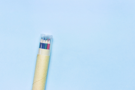 Color pencils in pencil case on blue background top view flat lay with copy space. Wooden colored pencils for drawing, objects for creativity, school supplies close-up. Back to school conceptの写真素材