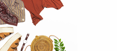 Stylish trendy feminine summer clothing skirt jacket suede sandals round rattan bag shawl wrist watch on white background. Female fashion background beauty or fashion blog concept Flat lay top view.の写真素材
