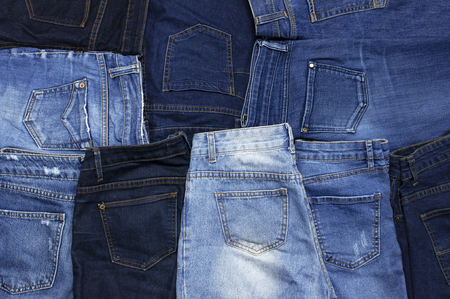 Set of different blue jeans top view flat lay. Detail of nice blue jeans. Jeans texture or denim background. Trend clothing. Collection of jeans, fashion background, clothing concept.の写真素材