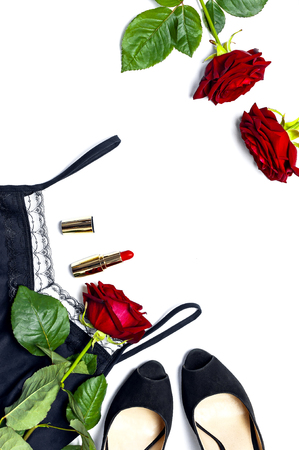 Female black T-shirt jacket with lace, classic shoes, red lipstick and rose flowers on white background top view flat lay. Beauty fashion background. Sexy clothes, fashion look, women's holidayの写真素材
