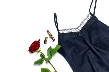 Female black T-shirt jacket with lace, red lipstick and rose flowers on white background top view flat lay. Beauty fashion background. Sexy clothes, fashion look, women's holidayの写真素材