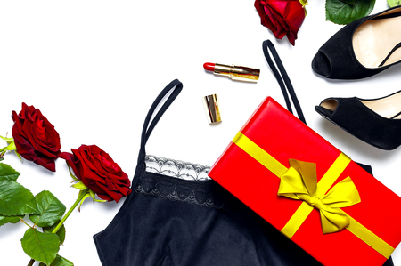 Female black T-shirt jacket with lace, classic shoes, gift box, red lipstick and rose flowers on white background top view flat lay. Beauty fashion background. Sexy clothes, women's holidayの写真素材