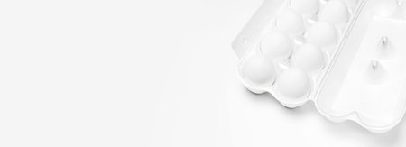 White chicken eggs in white packaging on light background top view flat lay copy space. Eggs in box,...