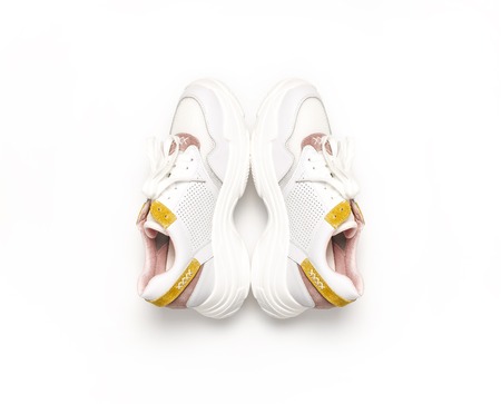 White female sneakers on white background. Women Fashion blog or magazine concept.  shoes, trendy sneakers, fashion, style, lifestyle.の写真素材