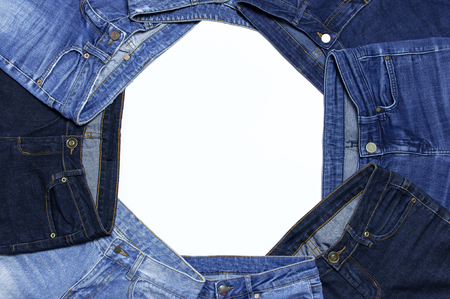 Frame of different blue jeans isolated on white background top view flat lay. Detail of nice blue jeans. Jeans texture or denim background. Trend clothing. Beauty and fashion, clothing conceptの写真素材