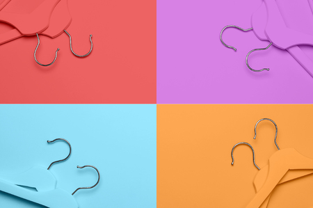 Creative fashion concept. Flat lay top view colored wooden hangers on multi-colored background minimalism style pop-art. Sale discount store shopping concept, design empty hanger feminine blog.の写真素材