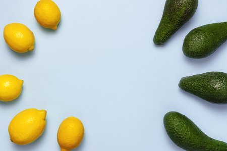 Ripe fresh avocado and fresh citrus lemons on pastel blue background top view Flat lay copy space. Fruits Healthy food concept, diet, healthy lifestyleの写真素材