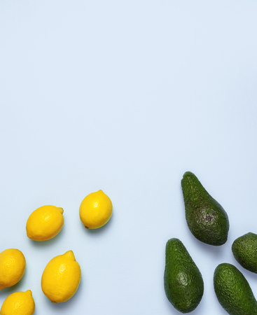 Ripe fresh avocado and fresh citrus lemons on pastel blue background top view Flat lay copy space. Fruits Healthy food concept, diet, healthy lifestyleの写真素材