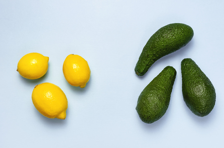 Ripe fresh avocado and fresh citrus lemons on pastel blue background top view Flat lay copy space. Fruits Healthy food concept, diet, healthy lifestyleの写真素材