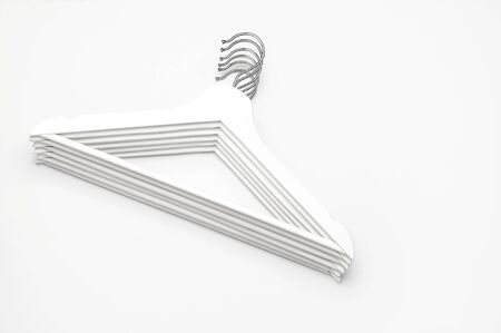 Flat lay top view White wooden hangers on white background copy space minimalism style. Sale discount store shopping concept, design empty hanger. Creative fashion beauty background. Feminine blog.の写真素材