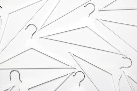 Flat lay top view White wooden hangers on white background copy space minimalism style. Sale discount store shopping concept, design empty hanger. Creative fashion beauty background. Feminine blog.の写真素材