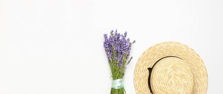 Summer fashion composition. Fresh flowers of purple lavender, women's summer straw hat on light gray background. Flat lay top view copy space. Lavender floral background flower card. Female accessory.の写真素材