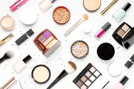 Pattern from Set of decorative cosmetics mascara powder lipstick eyeshadow blush makeup brush, star confetti on light background top view Flat lay. Beauty blogger concept. Fashion background. Makeup.の写真素材