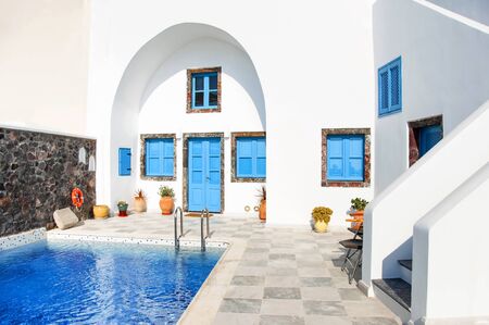 Classic white Greek architecture with blue doors and shutters, Santorini, Greece, Aegean sea, Europe. Travel concept, details of the one of the most beautiful travel destinations of the world.の写真素材