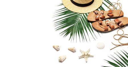 Woman's beach accessories flat lay. Straw hat, leather sandals, tropical palm leaves, seashells, starfish on white background. Top view copy space. Summer backdrop.の写真素材