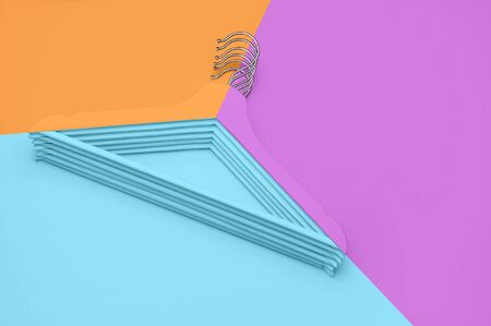 Creative fashion concept. Flat lay top view colored wooden hangers on blue pink orange neon background minimalism style pop-art. Sale discount store shopping concept design empty hanger feminine blog.の写真素材