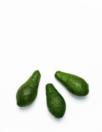 Ripe fresh avocado isolated on white background with shadow top view Flat lay copy space. Fruits Healthy food concept, diet, healthy lifestyle, organic avocado.の写真素材