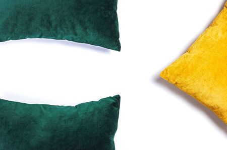Bright decorative soft pillows isolated on white background top view. Emerald and orange pillow, interior item, comfort.の写真素材