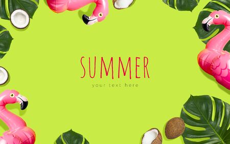 Creative summer beach concept. Inflatable pink mini flamingo tropical leaf monstera coconut on green background, pool float party. Flat lay copy space. Flamingo Trend Inflatable Toy. Summer background.の写真素材