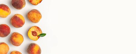 Flat lay composition with peaches. Ripe juicy peaches with green leaves on white background. Flat lay, top view, copy space.の写真素材