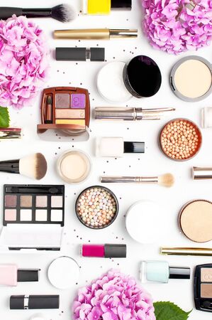 Pattern from Set of decorative cosmetics mascara powder lipstick eyeshadow blush makeup brush, star confetti on light backgroundの写真素材