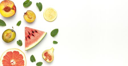 Tropical Summer Fruit Concept. Creative layout made of fresh ripe watermelon, peach, plum, fig, lemon, grapefruit and mint leaves on white background. Flat lay, top view, copy space. Food background.の写真素材