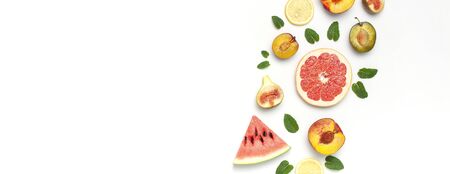 Tropical Summer Fruit Concept. Creative layout made of fresh ripe watermelon, peach, plum, fig, lemon, grapefruit and mint leaves on white background. Flat lay, top view, copy space. Food background.の写真素材
