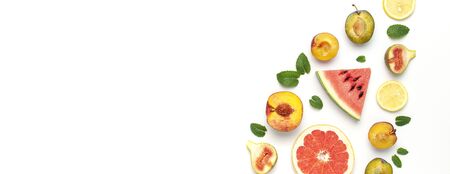 Tropical Summer Fruit Concept. Creative layout made of fresh ripe watermelon, peach, plum, fig, lemon, grapefruit and mint leaves on white background. Flat lay, top view, copy space. Food background.の写真素材