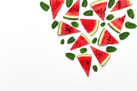 Watermelon pattern. Juicy slices of ripe red watermelon and mint leaves on white background. Flat lay, top view, copy space.の写真素材
