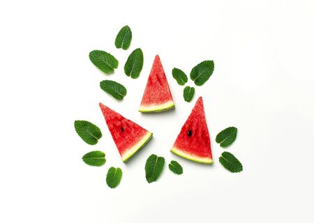 Watermelon pattern. Juicy slices of ripe red watermelon and mint leaves on white background. Flat lay, top view, copy space.の写真素材