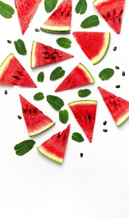 Watermelon pattern. Juicy slices of ripe red watermelon and mint leaves on white background. Flat lay, top view, copy space.の写真素材