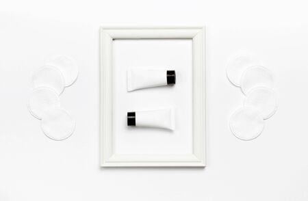 White cosmetic bottle containers on white background top view flat lay with space for text.の写真素材