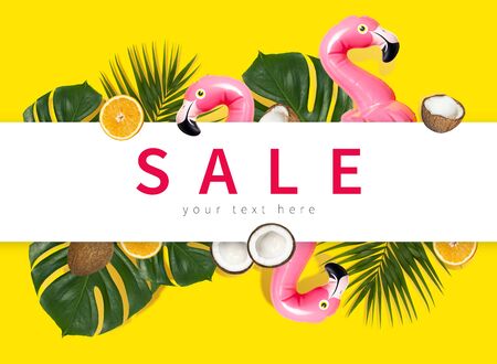 Creative concept of summer sales. Inflatable pink mini flamingo tropical palm leaf monstera coconut orange on yellow background pool float party. Flat lay Flamingo Trend Inflatable Toy Discounts sale.の写真素材