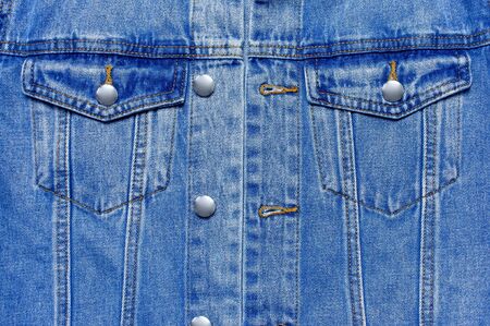 Close-up Blue denim jacket on isolated white background top view flat lay copy space. Denim, fashionable jacket, women's or men's trend clothing, fashion background. Store concept, sale.の写真素材