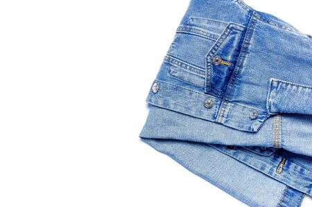 Close-up Blue denim jacket on isolated white background top view flat lay copy space. Denim, fashionable jacket, women's or men's trend clothing, fashion background. Store concept, sale.の写真素材